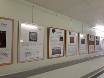 Photograph showing framed images on a corridor wall