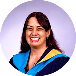 image of a woman in graduation robes, smiling